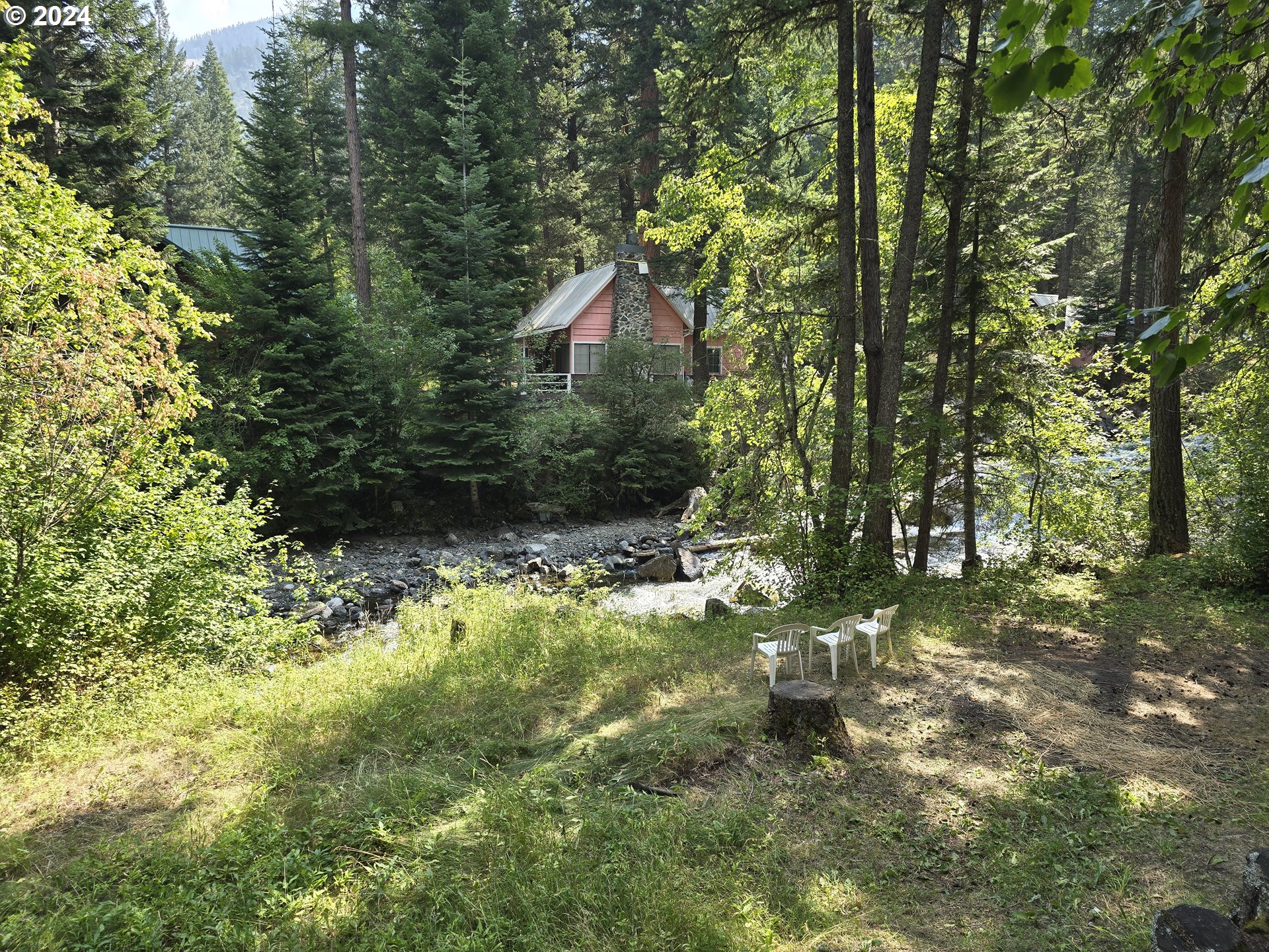 59975 Pollock Road Joseph, OR 97846 - Photo 32 of 34 a backyard of a house with a yard and outdoor seating