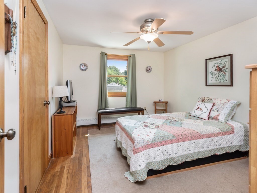 14 Killdeer Road Webster, MA 01570 - Photo 17 of 30 a bedroom with a bed and a chandelier