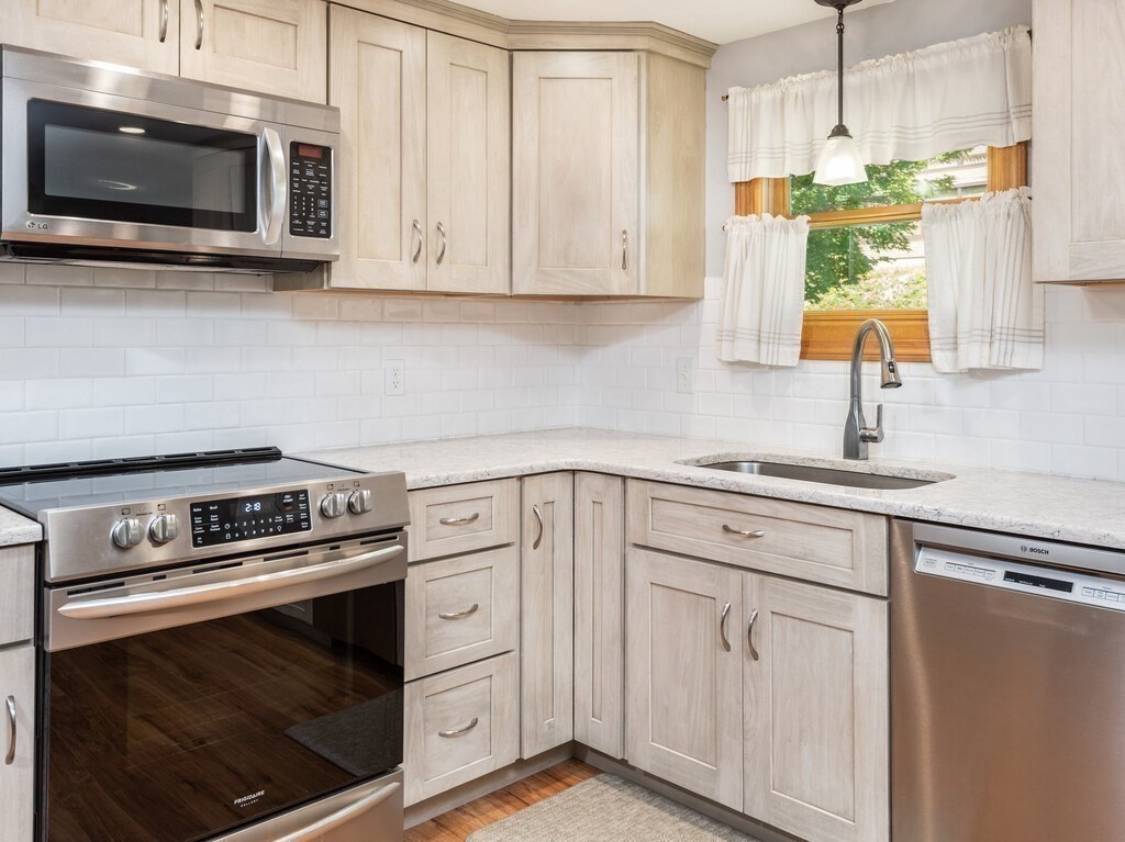 14 Killdeer Road Webster, MA 01570 - Photo 6 of 30 a kitchen with white cabinets stainless steel appliances and sink