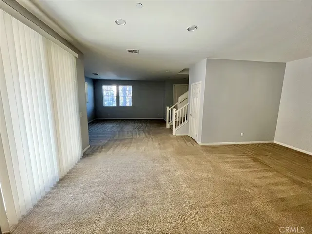 a kitchen with stainless steel appliances a sink a stove a microwave a center island and a window