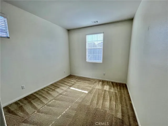 a view of a room with wooden floor and window