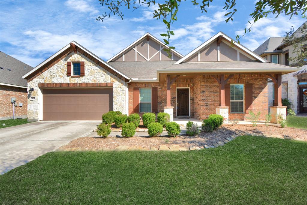9614 Hideaway Green Drive Richmond, TX 77406 - Photo 1 of 26 a front view of a house with a yard and potted plants