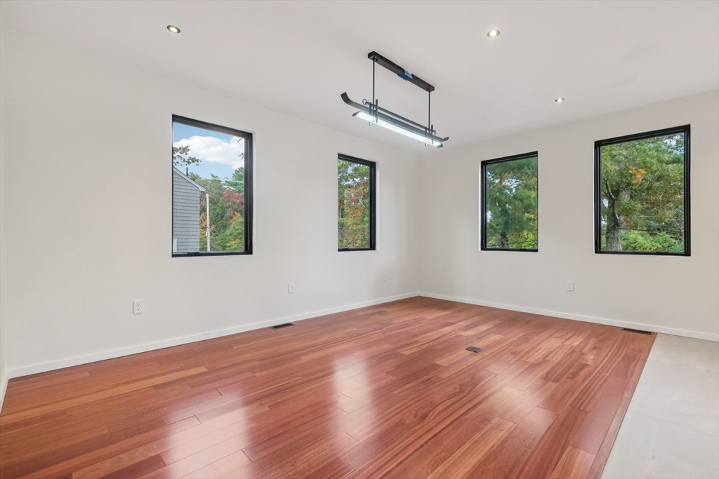 883 Greendale Avenue Needham, MA 02492 - Photo 14 of 42 a view of an empty room with wooden floor and a window