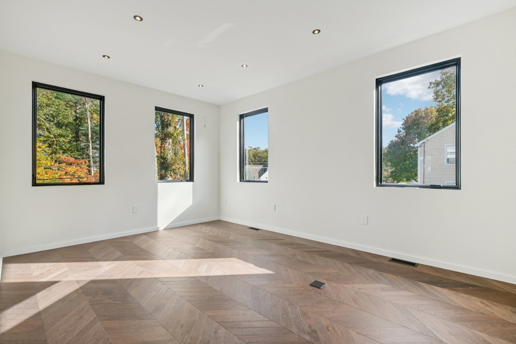 883 Greendale Avenue Needham, MA 02492 - Photo 16 of 42 a view of an empty room with window and wooden floor