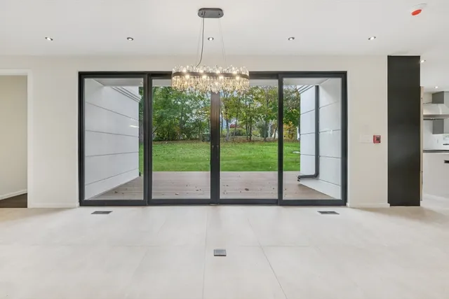 a view of a room with floor to ceiling windows and an outdoor view