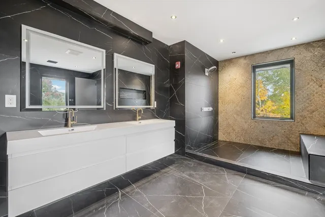 a spacious bathroom with a sink mirror and vanity