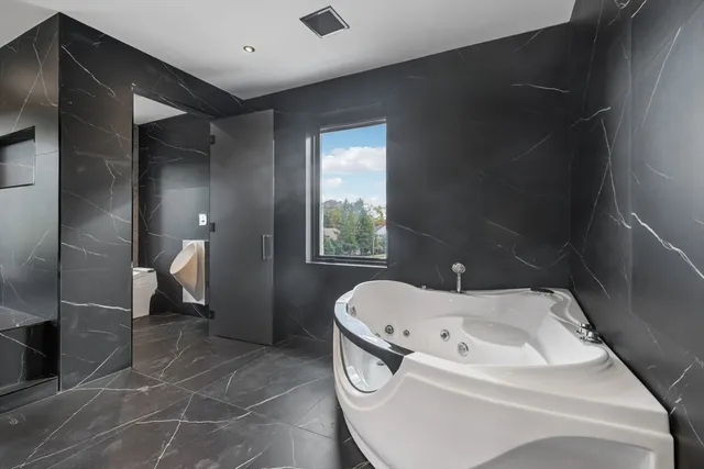 a bathroom with a bathtub and a shower
