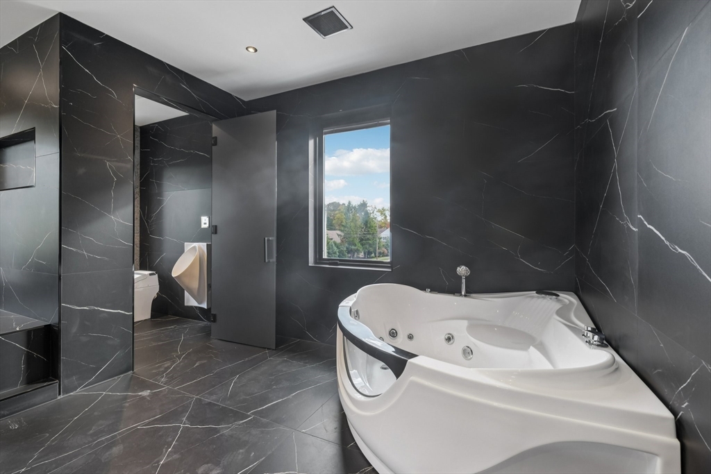 883 Greendale Avenue Needham, MA 02492 - Photo 23 of 42 a bathroom with a bathtub and a shower