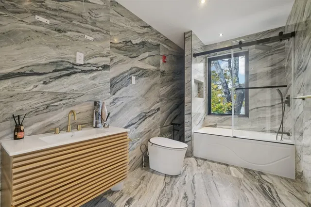 a bathroom with a toilet a sink and mirror