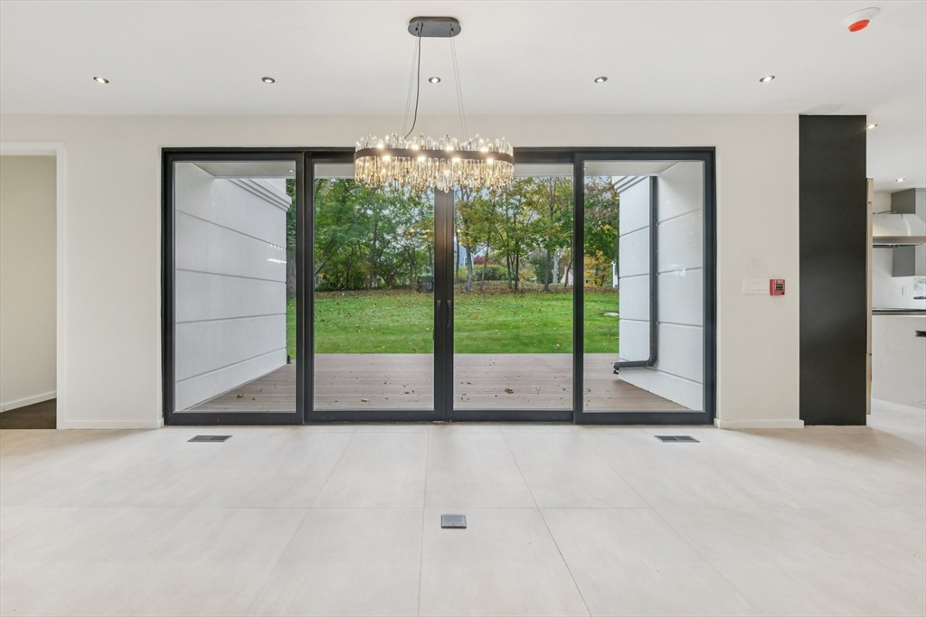 883 Greendale Avenue Needham, MA 02492 - Photo 3 of 42 a view of a room with floor to ceiling windows and an outdoor view