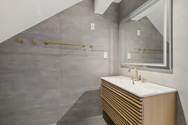 a bathroom with a sink a vanity and a mirror