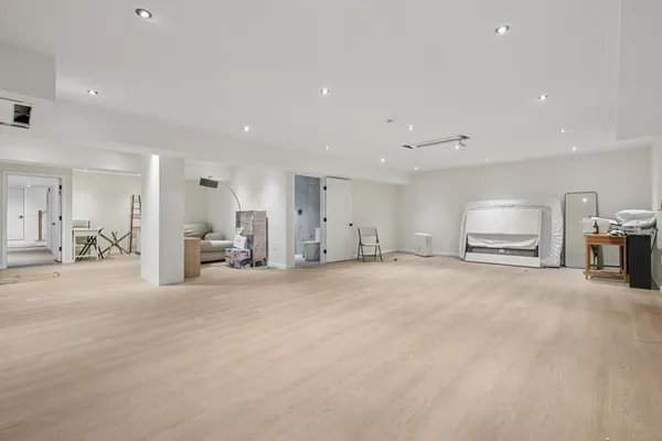 a view of a kitchen with a sink and a large mirror in a room