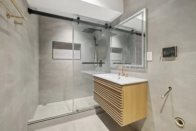 a bathroom with a sink a mirror and a shower