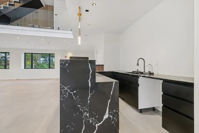 a kitchen with a sink cabinets and window