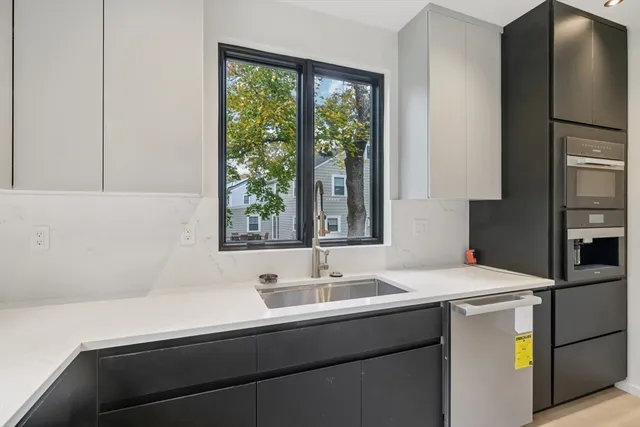 a kitchen with a sink and a refrigerator