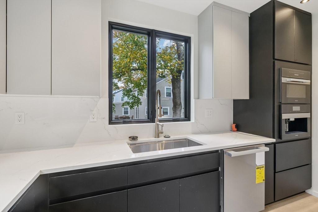 883 Greendale Avenue Needham, MA 02492 - Photo 8 of 42 a kitchen with a sink and a refrigerator
