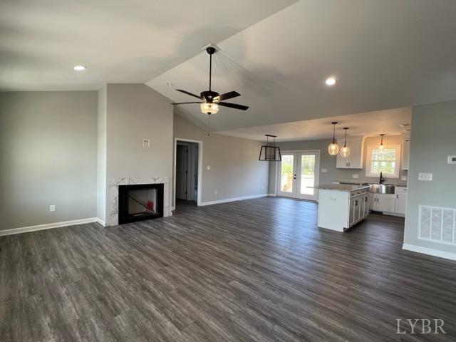 5794 Stage Road Concord, VA 24538 - Photo 4 of 32 an empty room with wooden floor fireplace and windows