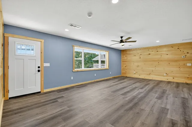 a kitchen with granite countertop a sink cabinets and wooden floor
