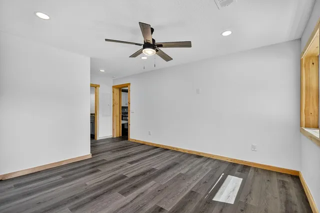 a bathroom with a granite countertop sink a vanity and a window