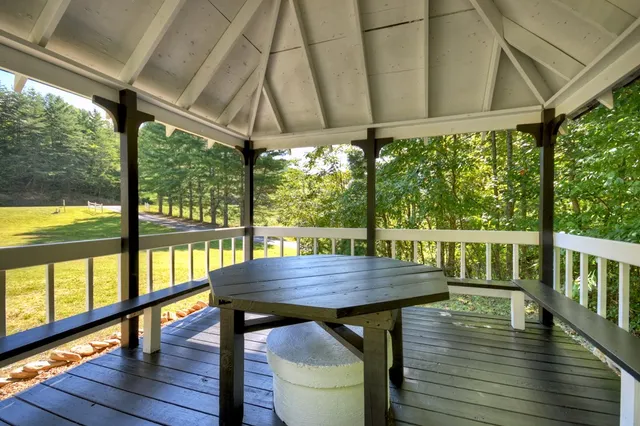 a view of balcony with wooden floor and outdoor seating