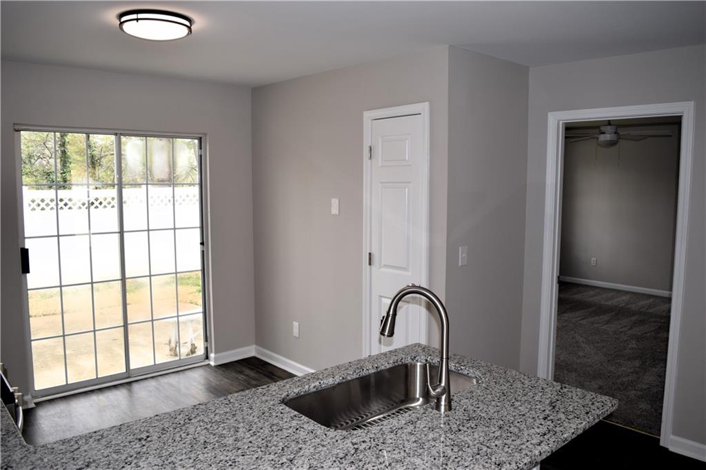253 Woodland Way Canton, GA 30114 - Photo 6 of 28 a view of a kitchen with granite countertop a sink and a window