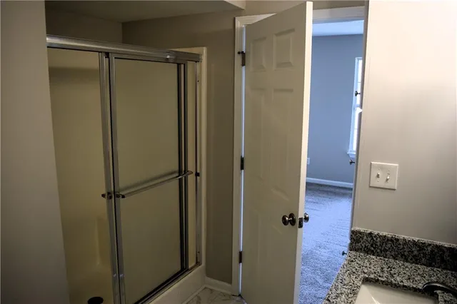 a bathroom with a glass shower door