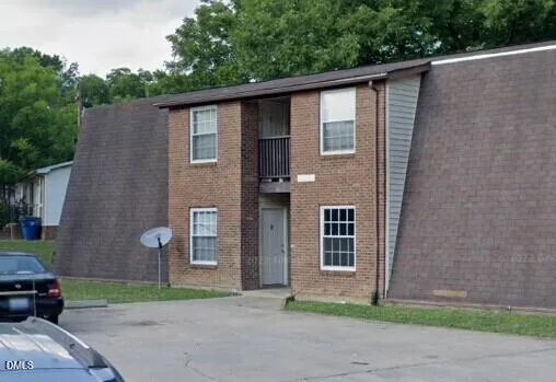 a front view of a house with a garden and garage