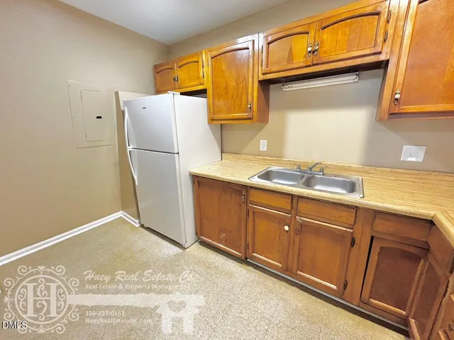a kitchen with stainless steel appliances granite countertop a refrigerator a sink and dishwasher