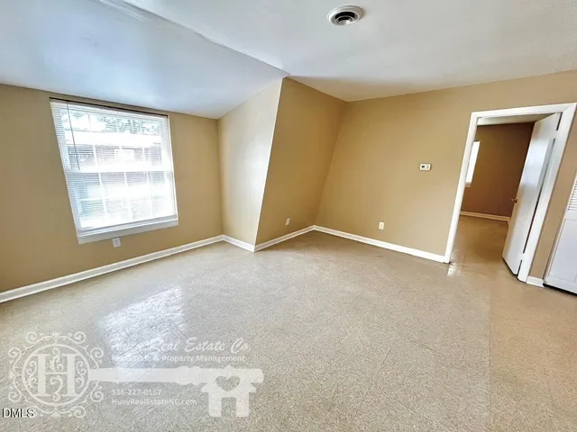 a view of an empty room with a window