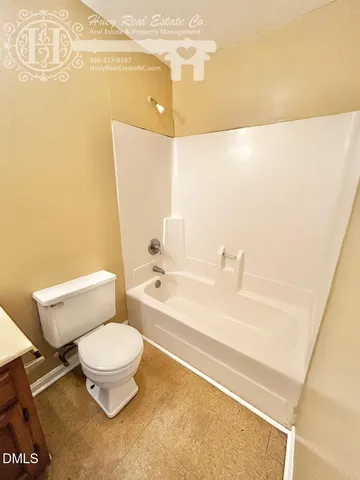 a bathroom with a toilet and a bathtub