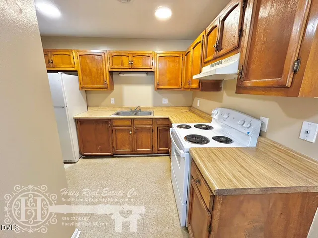 a kitchen that has a sink and a stove