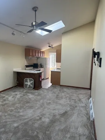 a view of a kitchen with a sink a stove top oven and cabinets