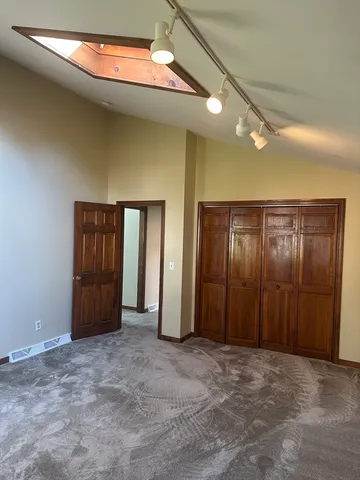 an empty room with closet and sliding door