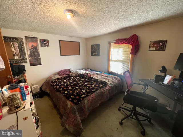 a bedroom with a bed and a desk