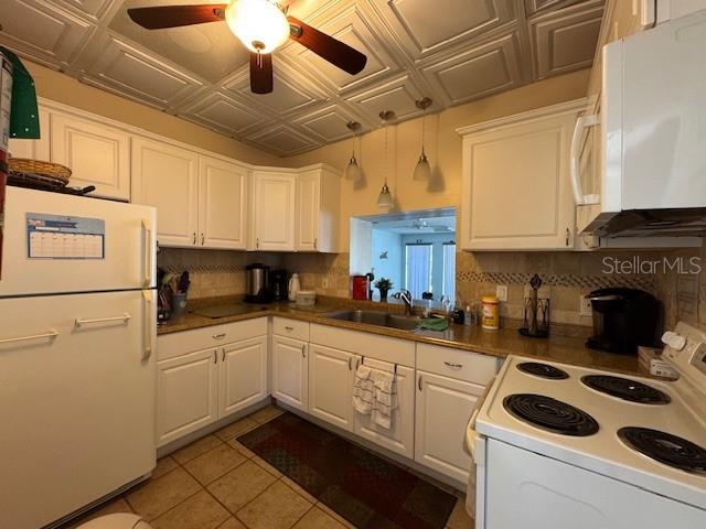11485 Oakhurst Road, Unit 319 Largo, FL 33774 - Photo 47 of 63 a kitchen with a sink cabinets and white appliances