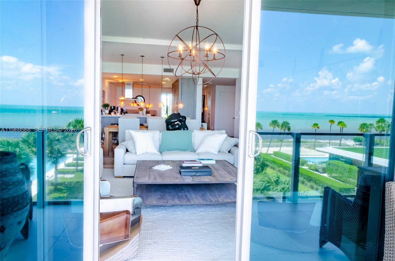 350 Ocean Drive, Unit 406N Key Biscayne, FL 33149 - Photo 19 of 41 a view of a dining room with furniture a chandelier and wooden floor