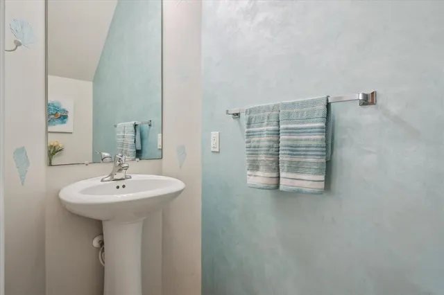 a bathroom with a sink a mirror and a window