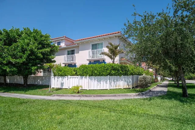 a front view of a house with a garden and yard