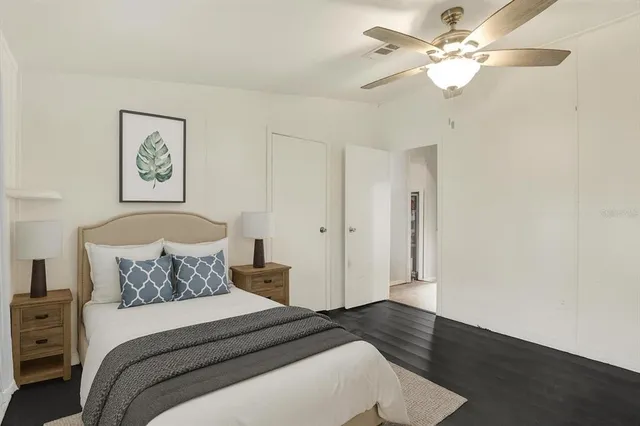 a bedroom with a bed and a ceiling fan