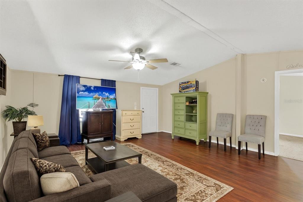 9211 Harney Baptist Church Road Tampa, FL 33637 - Photo 5 of 22 a living room with furniture and a flat screen tv