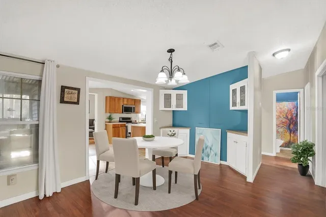 a view of a dining room with furniture wooden floor and chandelier