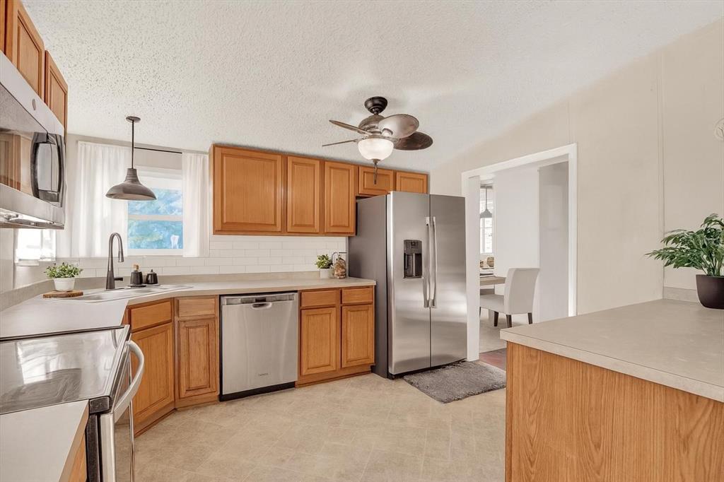 9211 Harney Baptist Church Road Tampa, FL 33637 - Photo 9 of 22 a kitchen with stainless steel appliances a stove a sink and a refrigerator