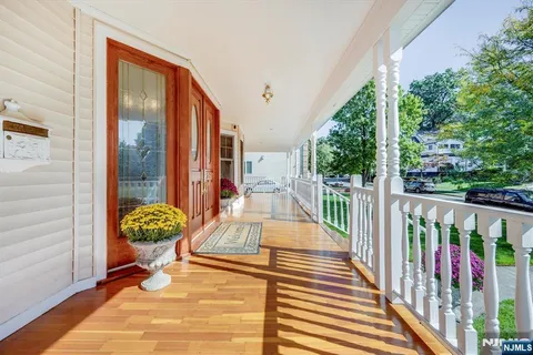 a view of a balcony with chairs and wooden floor