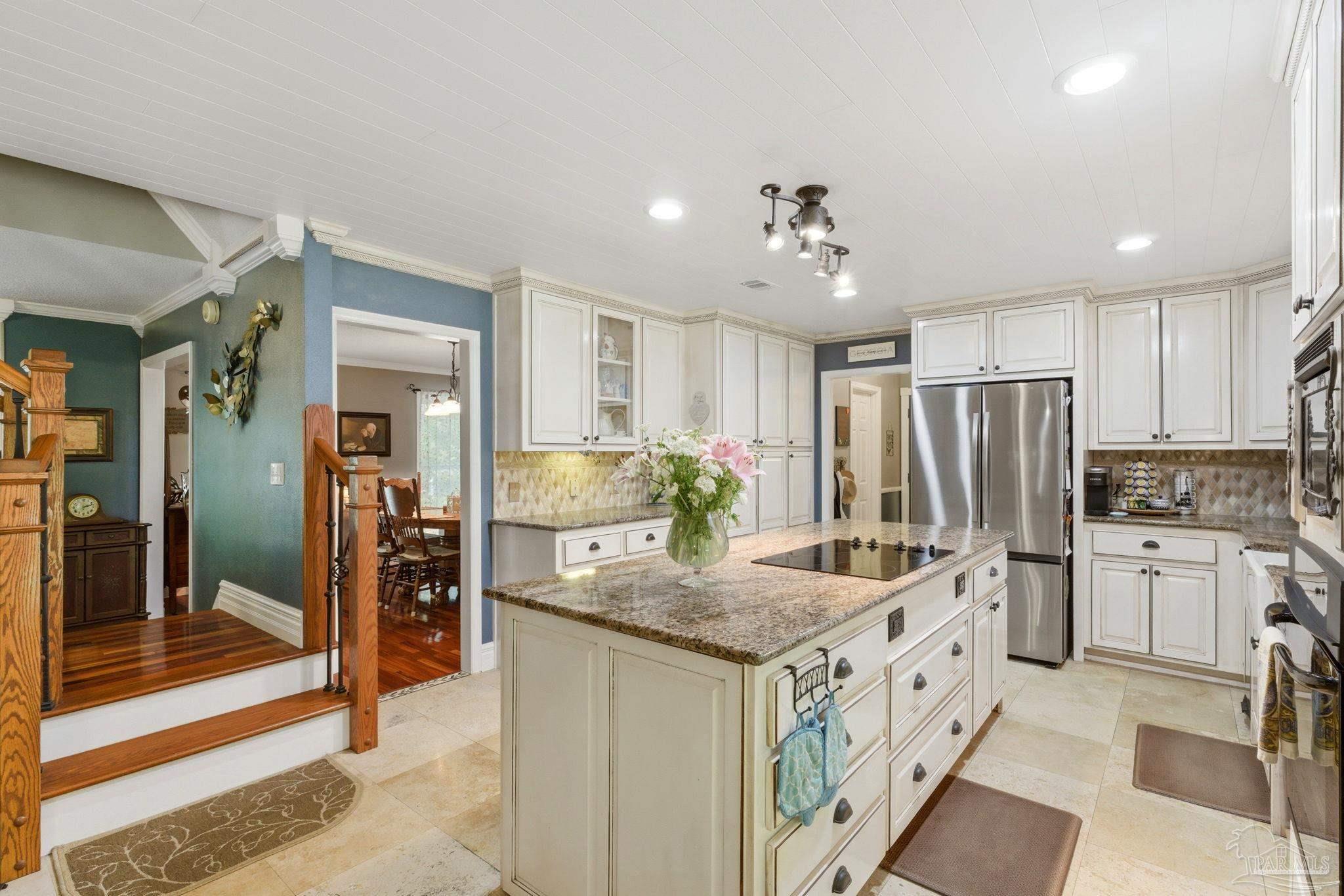 6930 Summit Way Milton, FL 32570 - Photo 17 of 71 a kitchen with stainless steel appliances granite countertop a sink and refrigerator
