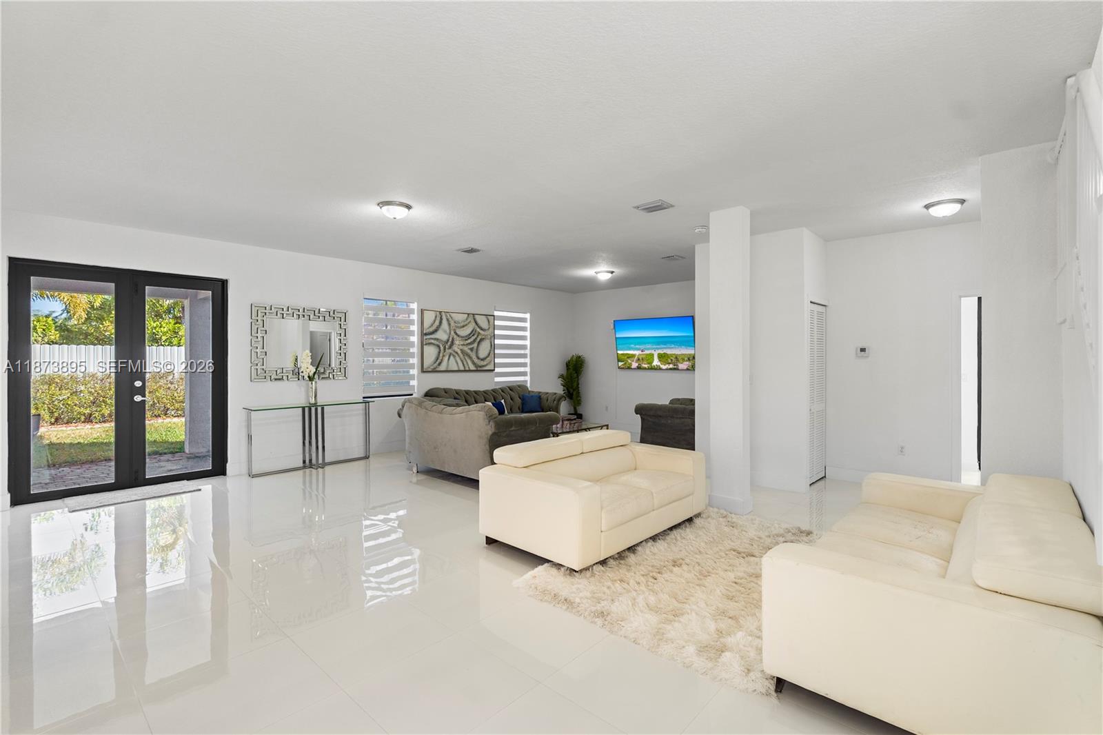 14841 Southwest 39th Terrace Miami, FL 33185 - Photo 13 of 57 a large room with a bed and a large window