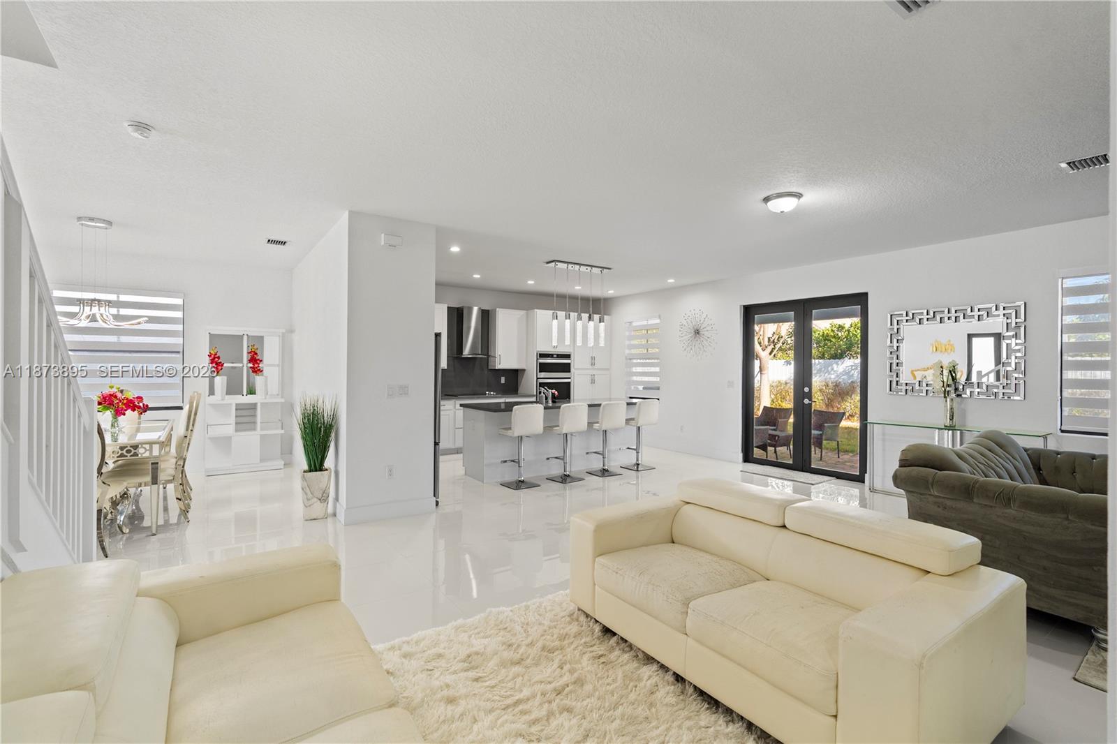 14841 Southwest 39th Terrace Miami, FL 33185 - Photo 14 of 57 a living room with furniture and a kitchen view