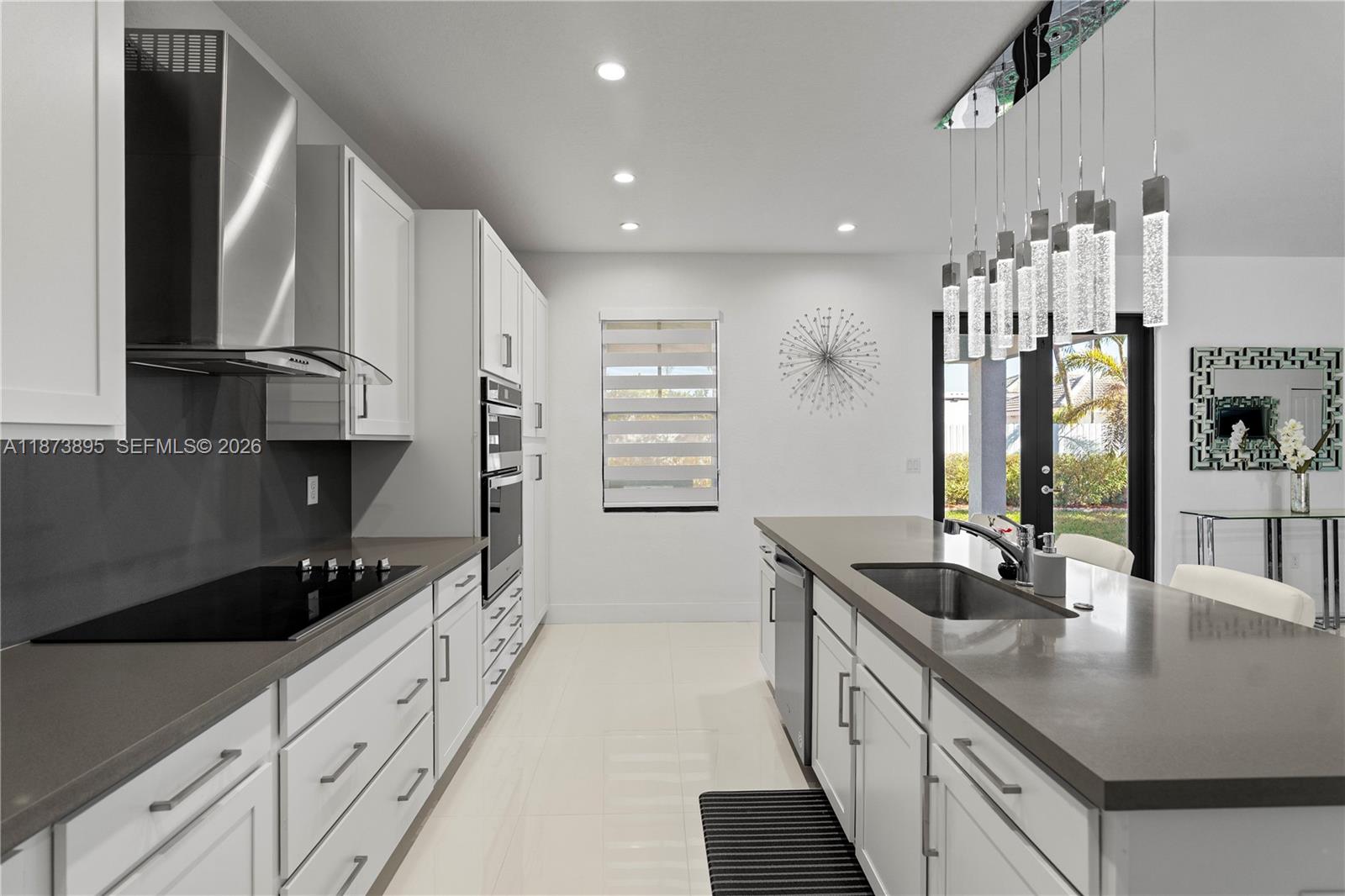 14841 Southwest 39th Terrace Miami, FL 33185 - Photo 22 of 57 a kitchen with stainless steel appliances a sink stove and cabinets