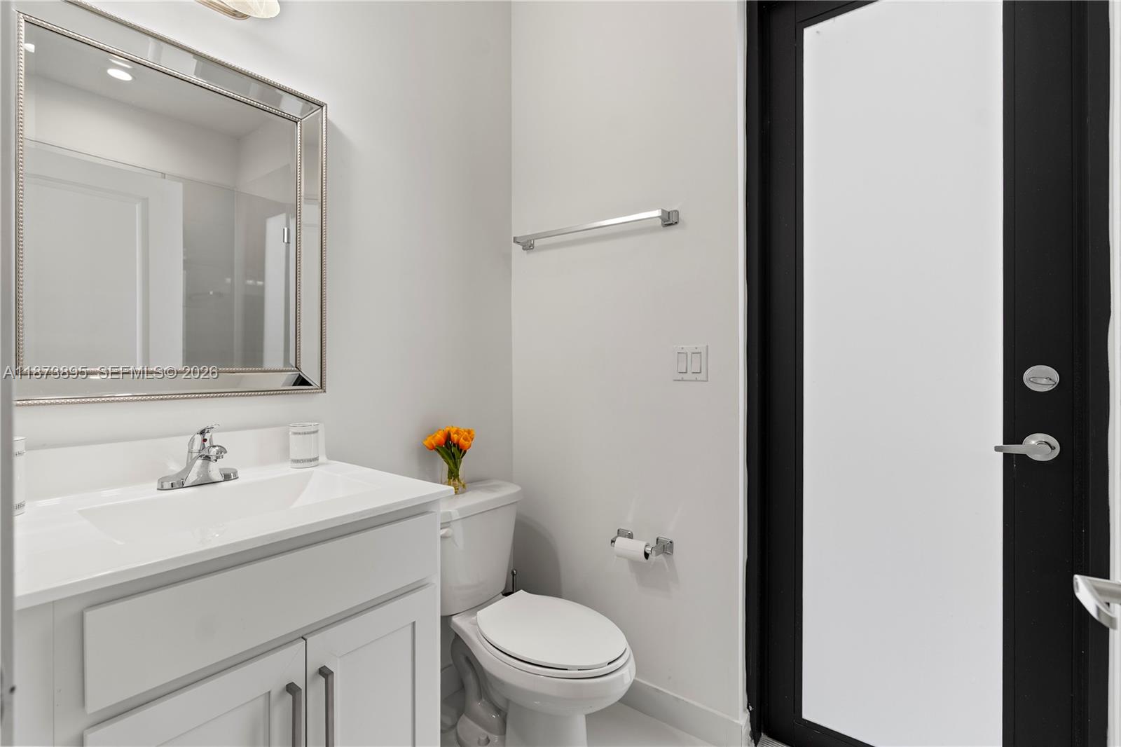 14841 Southwest 39th Terrace Miami, FL 33185 - Photo 24 of 57 a bathroom with a sink toilet and a mirror