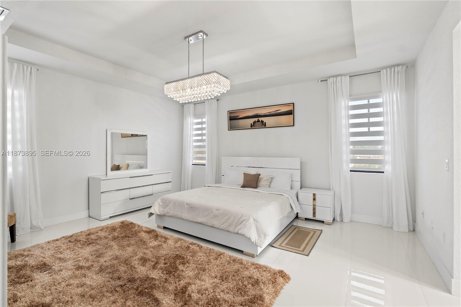 14841 Southwest 39th Terrace Miami, FL 33185 - Photo 33 of 57 a bedroom with a bed and a chandelier