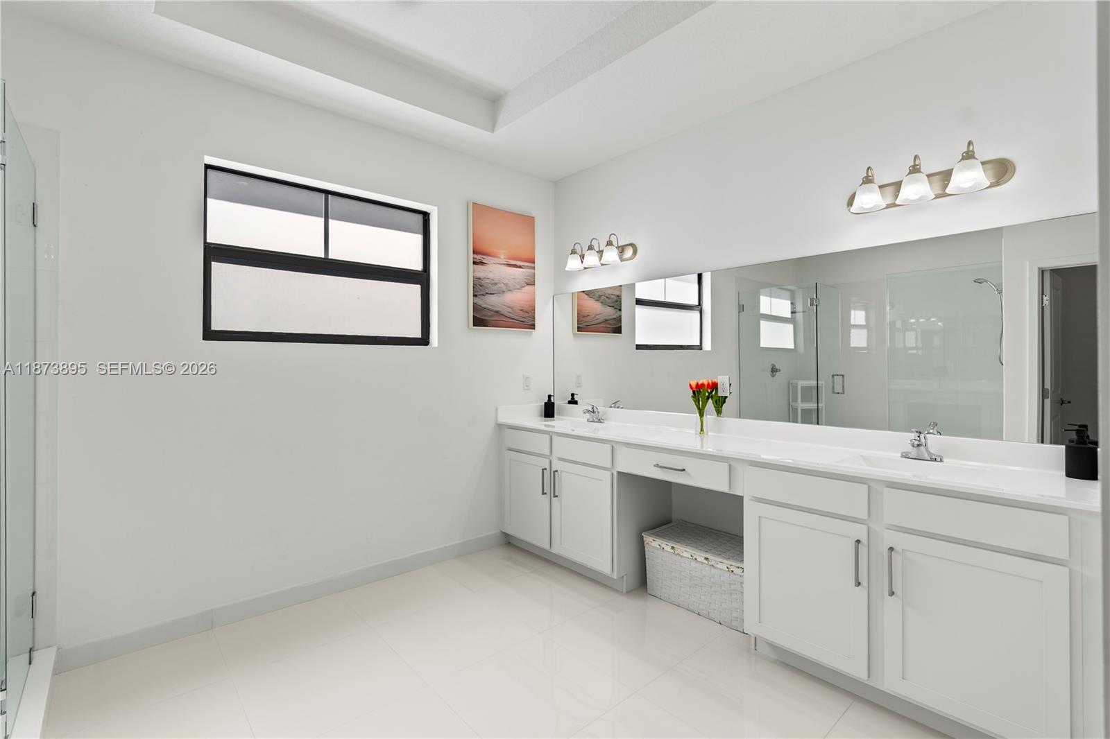 14841 Southwest 39th Terrace Miami, FL 33185 - Photo 35 of 57 a spacious bathroom with a double vanity sink a mirror and a bathtub